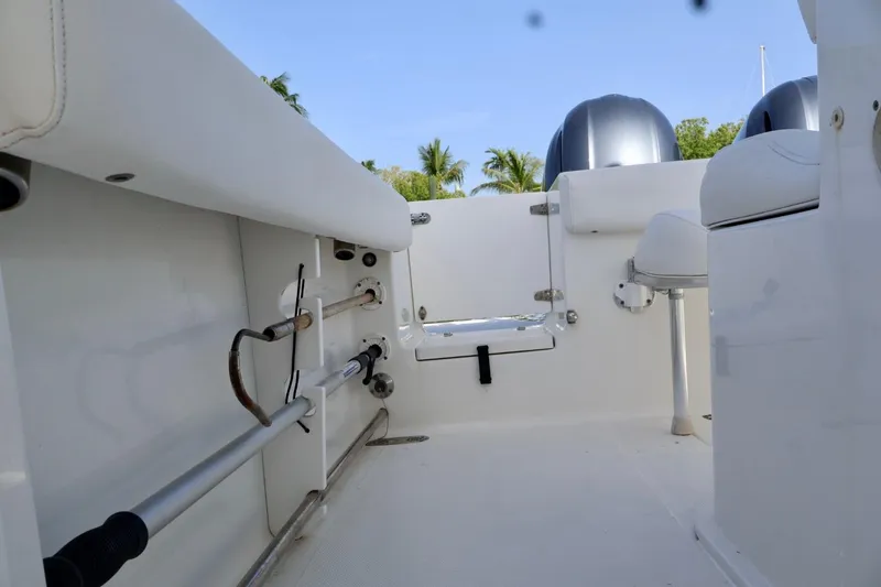 Slide: The Image of 2018 Sea Hunt Gamefish 27 Coffin Box interior with fishing rod holders and seating. - 8