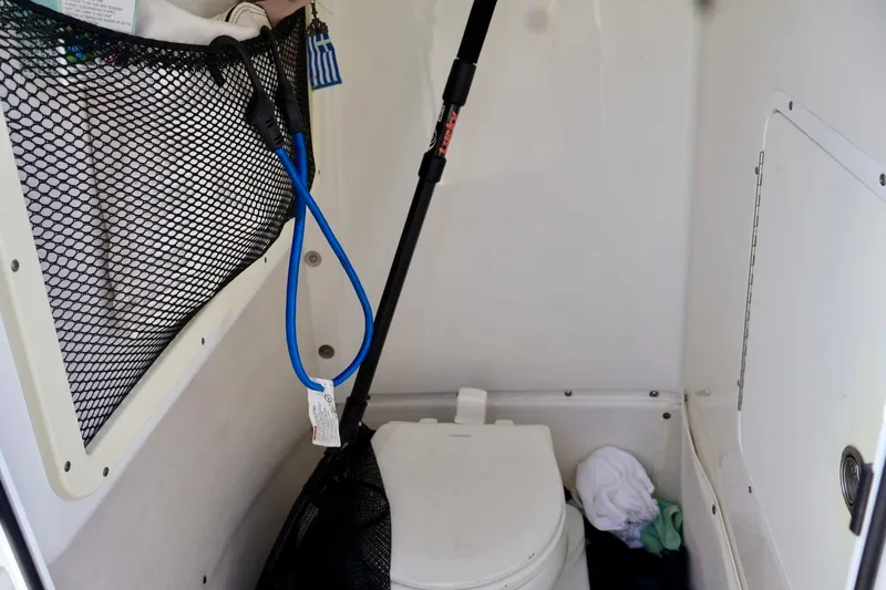Slide: The Image of Interior of 2018 Sea Hunt Gamefish 27 Coffin Box with storage net and marine toilet. - 23