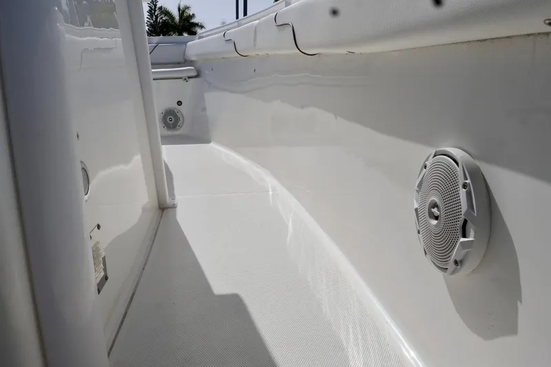 Slide: The Image of 2018 Sea Hunt Gamefish 27 Coffin Box boat interior with speakers and clean white deck. - 18