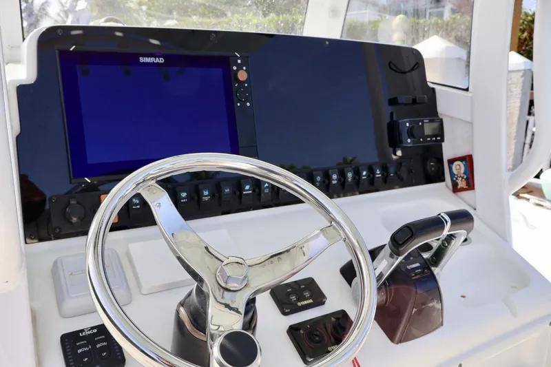 Slide: The Image of Control panel of 2018 Sea Hunt Gamefish 27 Coffin Box with steering wheel and navigation equipment. - 13