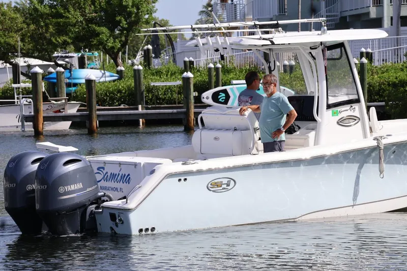 Slide: The Image of 2018 Sea Hunt Gamefish 27 Coffin Box boat with Yamaha engines docked in a marina. - 1