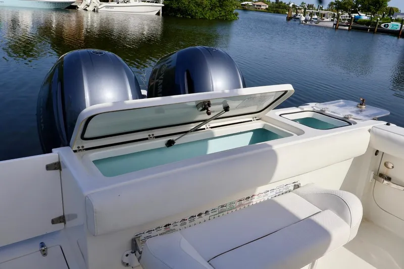 Slide: The Image of 2018 Sea Hunt Gamefish 27 Coffin Box with dual engines, open storage, and seating. - 9