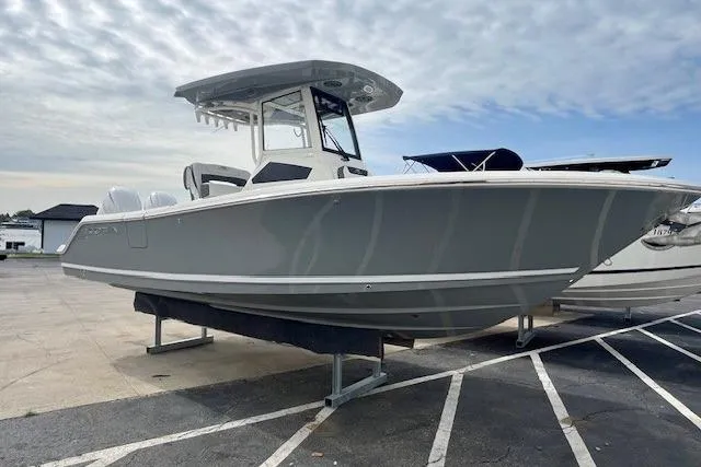 The Image of 2026 Cobia 245 Center Console boat displayed in a marina setting. - 0