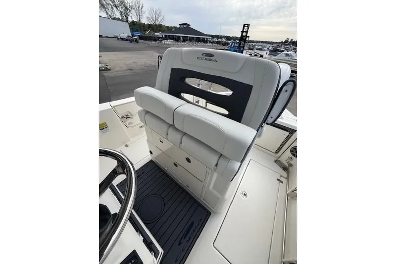 Slide: The Image of 2026 Cobia 245 Center Console boat interior with cushioned seating and storage compartments. - 10