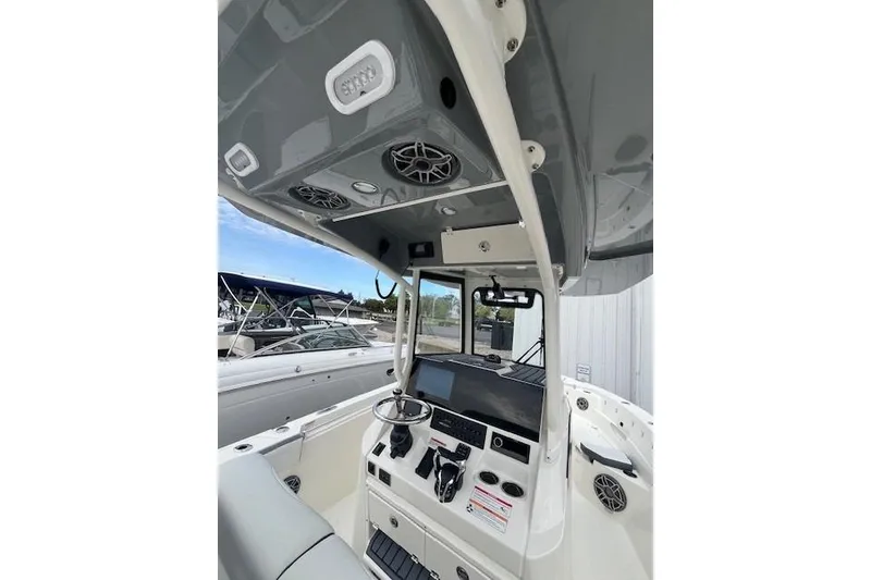 Slide: The Image of 2026 Cobia 245 Center Console boat interior with modern dashboard and controls. - 2