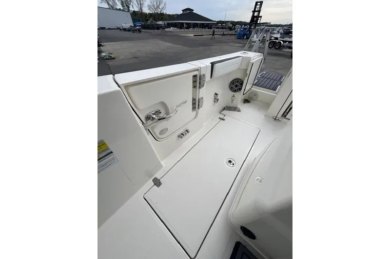Slide: The Image of 2026 Cobia 245 Center Console boat interior, featuring storage compartments and sleek design. - 13