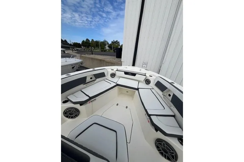 Slide: The Image of 2026 Cobia 245 Center Console boat interior with cushioned seating and speakers. - 9