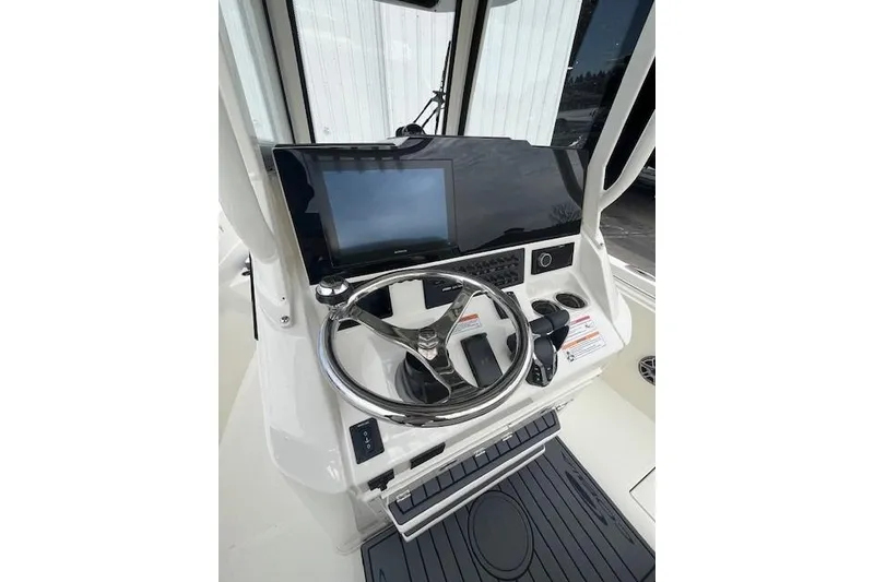 Slide: The Image of 2026 Cobia 245 Center Console boat helm with modern steering and controls. - 8