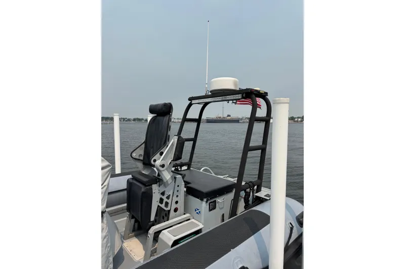Slide: The Image of 1996 Willard Marine Sea Force 730 boat with seating and radar, docked on calm water. - 11