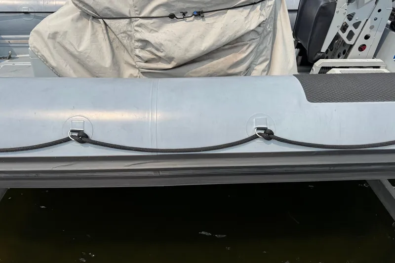 Slide: The Image of Inflatable side of a 1996 Willard Marine Sea Force 730 boat, docked. - 5