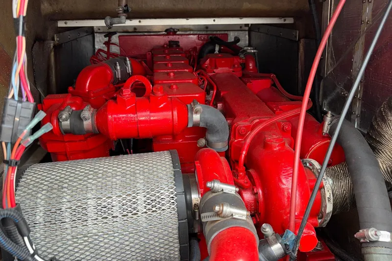Slide: The Image of Engine compartment of a 1996 Willard Marine Sea Force 730, featuring red components and wiring. - 17