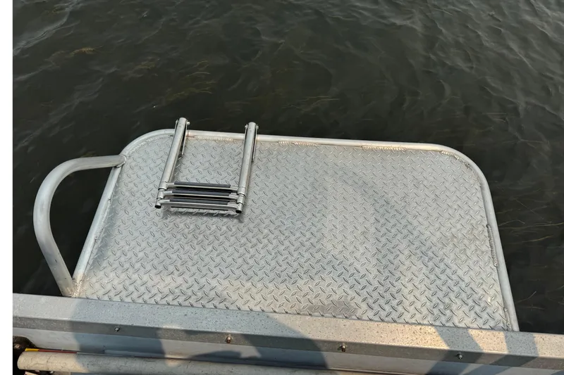 Slide: The Image of Aluminum boat platform with ladder, Willard Marine Sea Force 730, 1996 model, over water. - 8