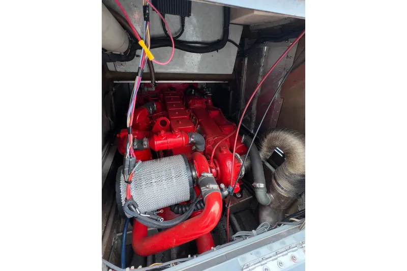 Slide: The Image of Engine compartment of a 1996 Willard Marine Sea Force 730 with red engine components. - 15