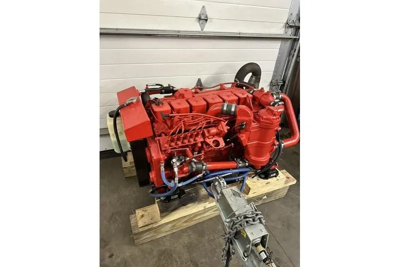 Slide: The Image of Red marine engine for 1996 Willard Marine Sea Force 730, displayed on wooden pallets. - 33