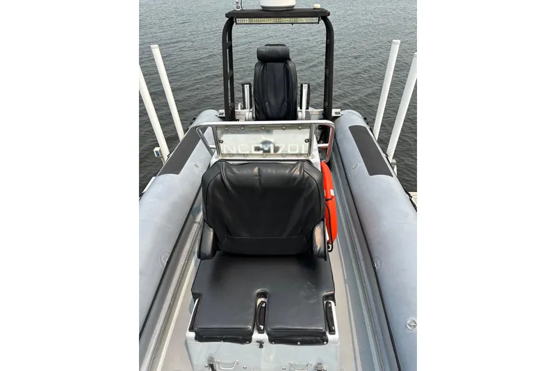 Slide: The Image of Willard Marine Sea Force 730 boat interior with black seats, 1996 model, on water. - 30