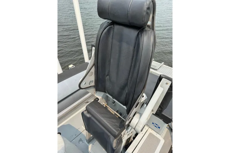 Slide: The Image of Captain's seat on a 1996 Willard Marine Sea Force 730 boat, overlooking water. - 13