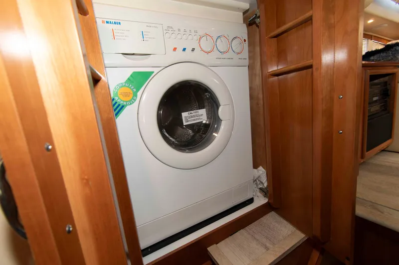 Slide: The Image of Washer and dryer unit inside a 2005 Carver 466 Motor Yacht cabin. - 25
