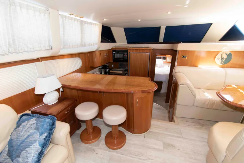 Slide: The Image of Interior of 2005 Carver 466 Motor Yacht with elegant wood finishes and cozy seating. - 16