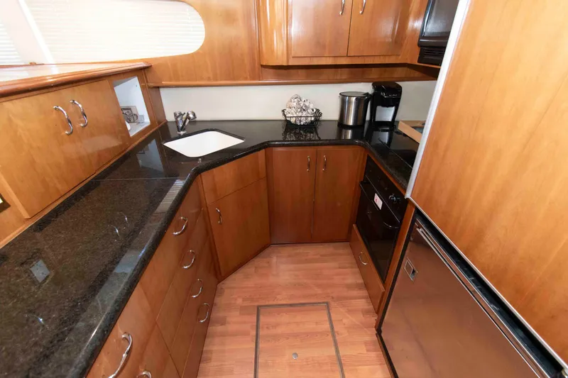 Slide: The Image of Luxurious kitchen interior of 2005 Carver 466 Motor Yacht with wood cabinetry and modern appliances. - 18