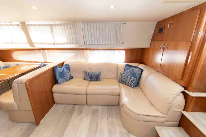 Slide: The Image of Luxurious interior of 2005 Carver 466 Motor Yacht with beige leather seating and blue cushions. - 13