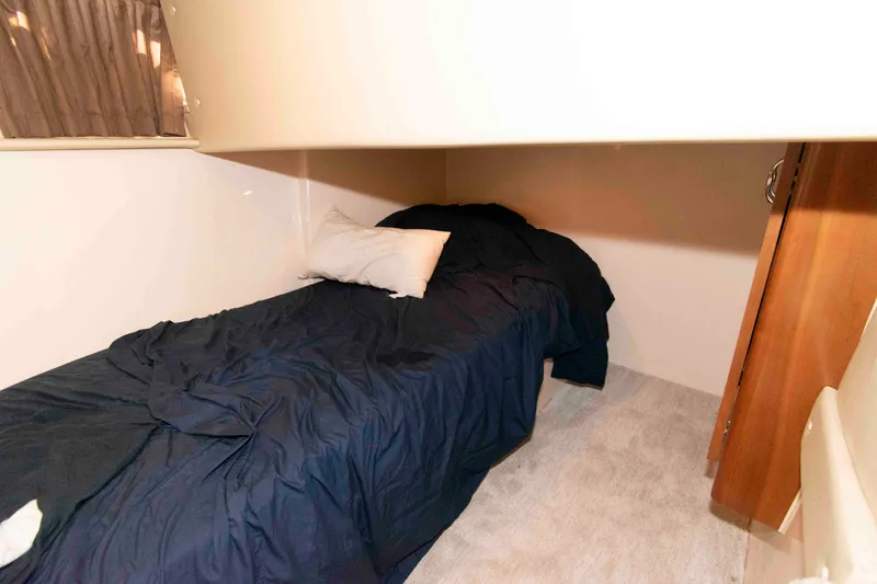 Slide: The Image of Cozy cabin interior of 2005 Carver 466 Motor Yacht with bed and window. - 23