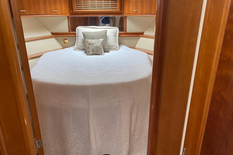 Slide: The Image of Luxurious bedroom interior of 2005 Carver 466 Motor Yacht with elegant bedding and wood accents. - 5
