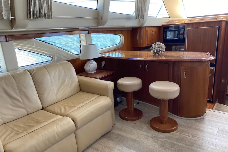 Slide: The Image of Luxurious interior of 2005 Carver 466 Motor Yacht with leather sofa and elegant bar area. - 8