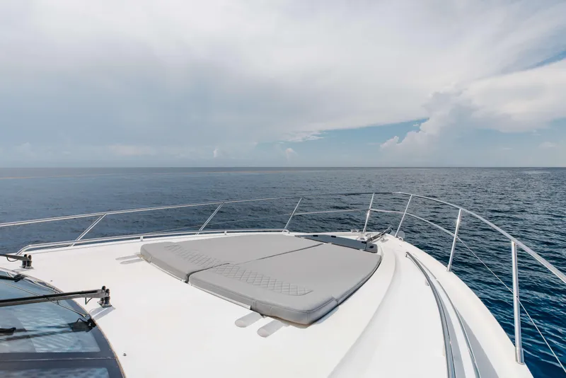 Slide: The Image of Bow view of 2012 Princess 60 yacht on open sea under cloudy sky. - 50