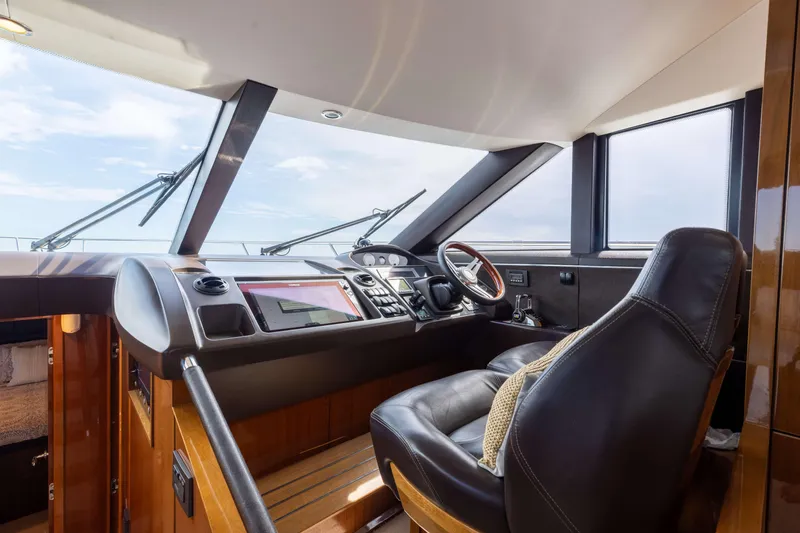 Slide: The Image of Luxurious helm of 2012 Princess 60 yacht with leather seating and modern controls. - 27