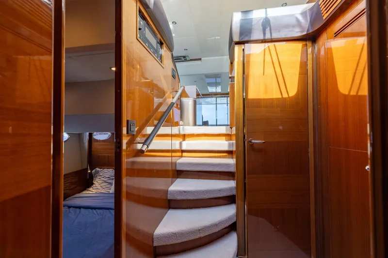 Slide: The Image of Luxurious interior of 2012 Princess 60 yacht with wooden finishes and carpeted stairs. - 28