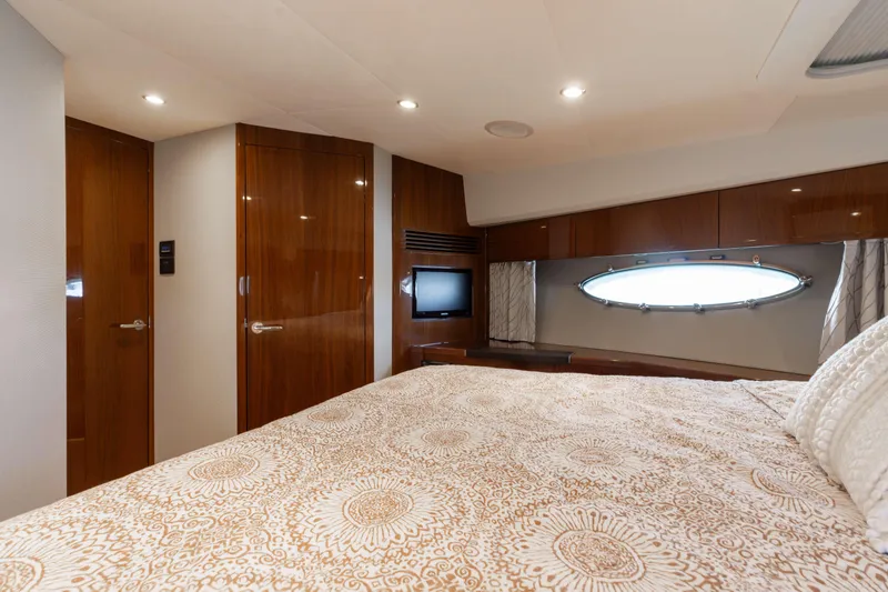 Slide: The Image of Luxurious cabin interior of 2012 Princess 60 yacht with elegant wood finishes and cozy bedding. - 37