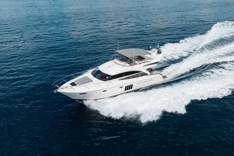 Slide: The Image of Luxury 2012 Princess 60 yacht cruising on open sea, creating dynamic water trails. - 9