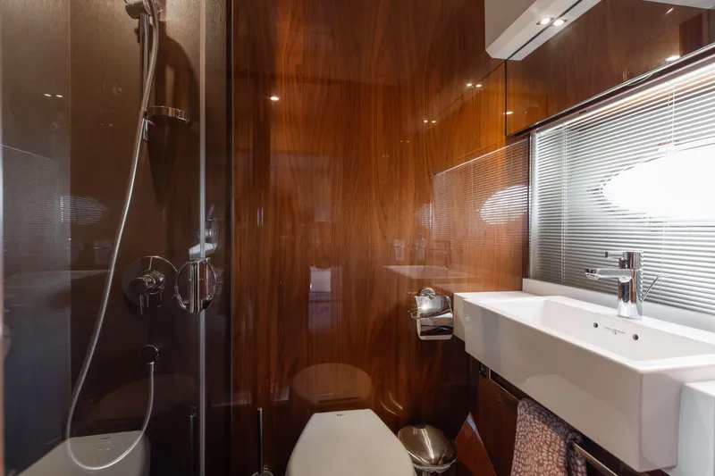 Slide: The Image of Luxurious bathroom interior of 2012 Princess 60 yacht with modern fixtures and wood paneling. - 40
