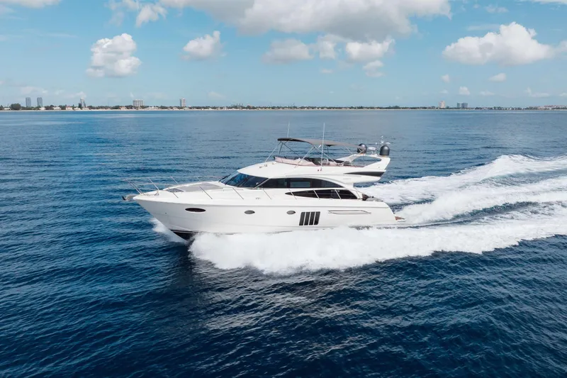 Slide: The Image of Luxurious 2012 Princess 60 yacht cruising on open water under a clear blue sky. - 7