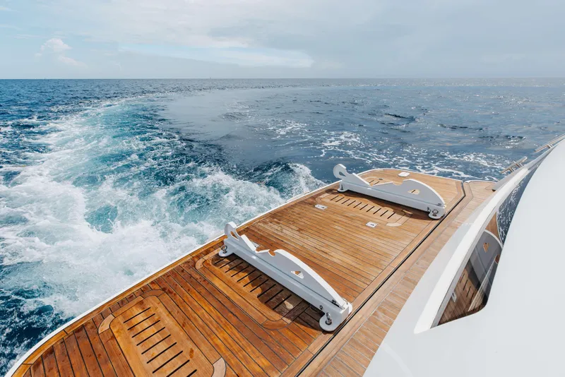 Slide: The Image of Luxury yacht Princess 60 cruising on open sea, showcasing elegant wooden deck, 2012 model. - 52