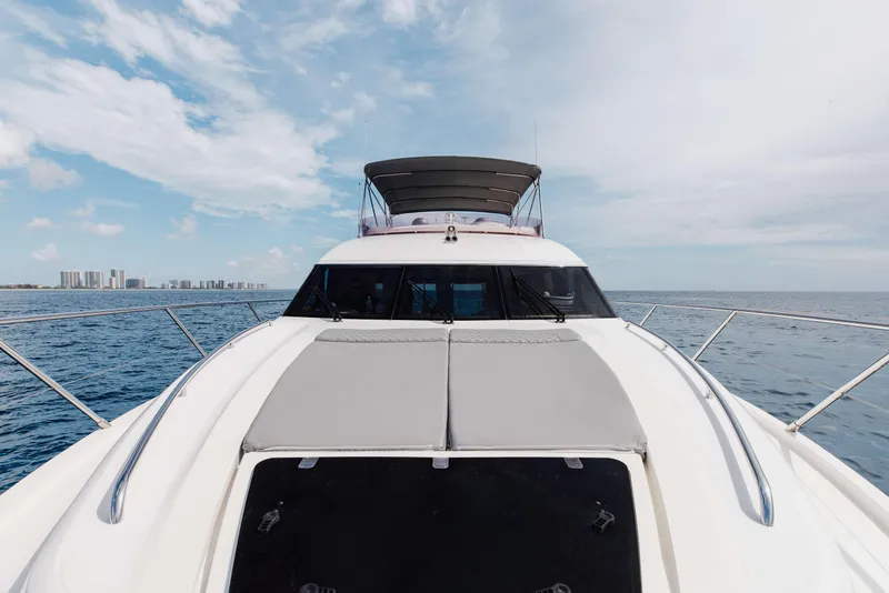 Slide: The Image of 2012 Princess 60 yacht cruising on open sea with city skyline in background. - 49