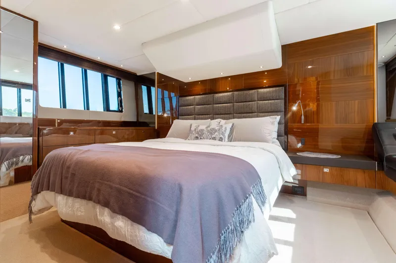 Slide: The Image of Luxurious bedroom interior of 2012 Princess 60 yacht with elegant wood paneling and large windows. - 29