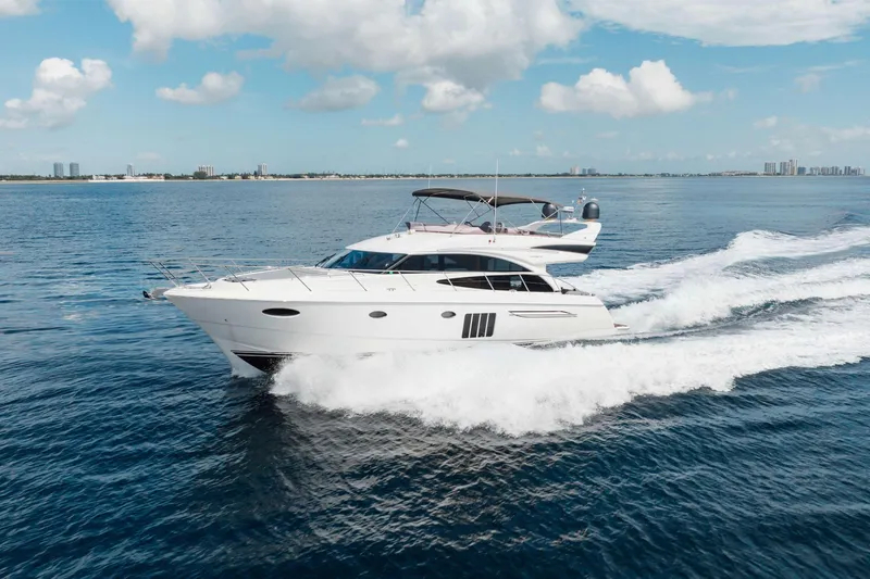 Slide: The Image of Luxury 2012 Princess 60 yacht cruising on open water under a clear sky. - 1