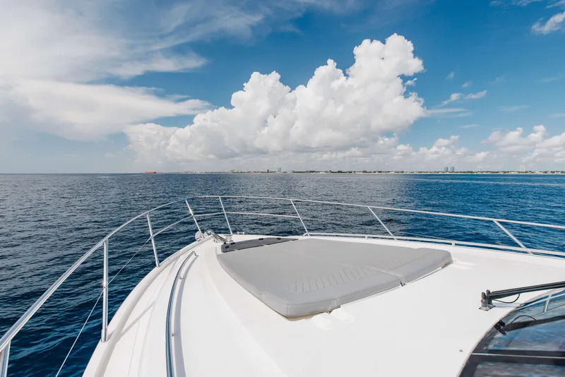 Slide: The Image of Bow view of 2012 Princess 60 yacht cruising on open sea under blue sky. - 51