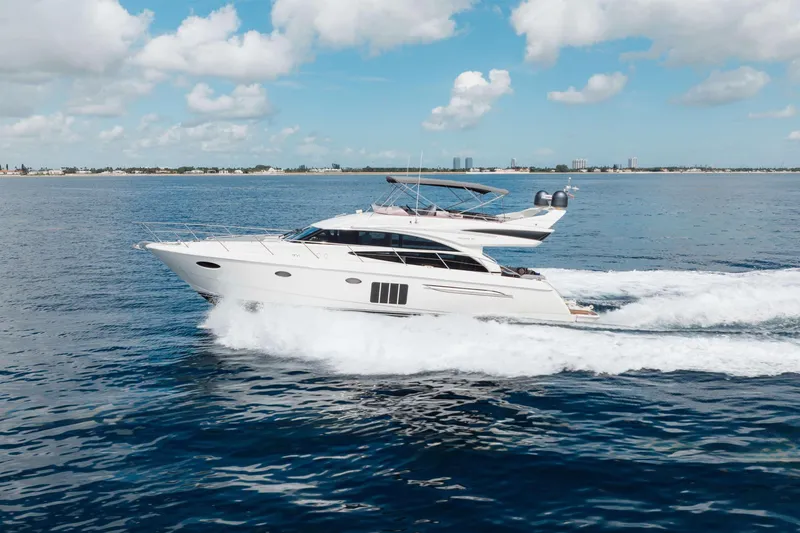 Slide: The Image of 2012 Princess 60 yacht cruising on open water under a clear blue sky. - 8