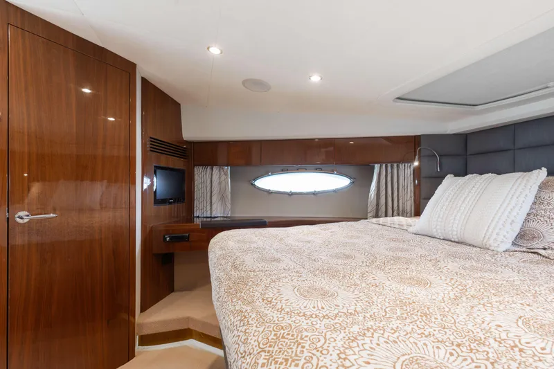 Slide: The Image of Luxurious cabin interior of 2012 Princess 60 yacht with elegant wood finishes and cozy bedding. - 36