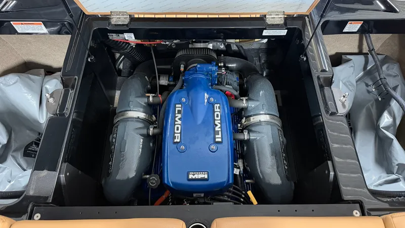 Slide: The Image of The engine compartment of a 2019 MasterCraft XT22 features an Ilmor engine with blue covers. - 20