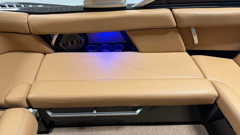 Slide: The Image of Interior of the 2019 MasterCraft XT22 with beige leather seating and blue lighting. - 38