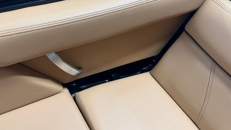 Slide: The Image of Close-up of beige leather seating in the interior of a MasterCraft XT22 boat. - 47