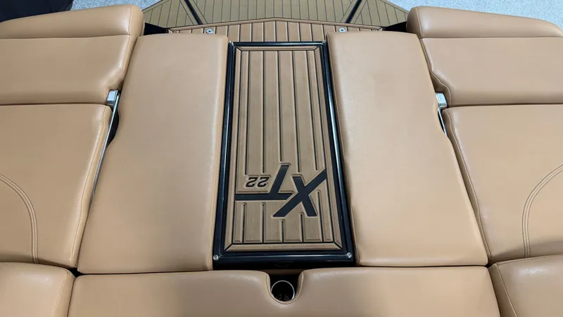 Slide: The Image of The image shows the rear deck of a 2019 MasterCraft XT22 with tan upholstery. - 19