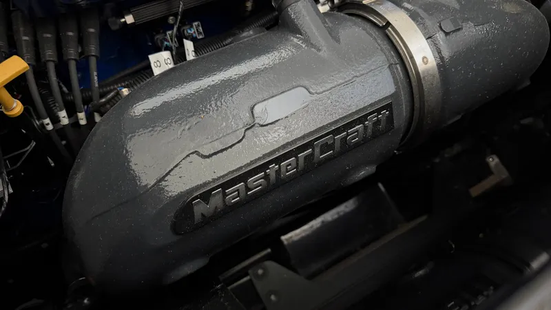 Slide: The Image of Close-up of a MasterCraft XT22 engine part with visible logo. - 22