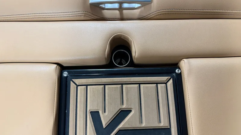 Slide: The Image of Close-up of a beige boat seat with a black insert and a cup holder. - 18