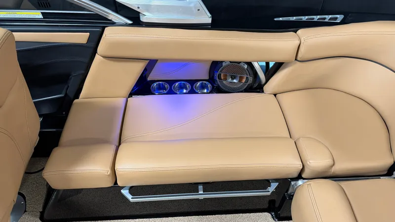 Slide: The Image of The image shows the interior of a 2019 MasterCraft XT22 with beige leather seating and blue lighting. - 23