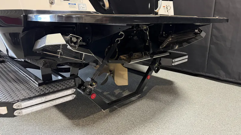 Slide: The Image of The image shows the stern of a 2019 MasterCraft XT22 boat with a sturdy trim tab system. - 7