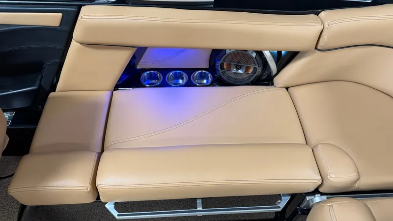 Slide: The Image of The image shows the interior of a 2019 MasterCraft XT22 with beige leather seating and blue lighting. - 25